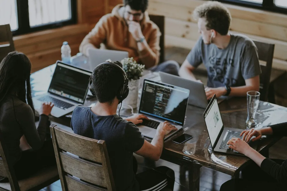 Suviara Forge software team working together on laptops